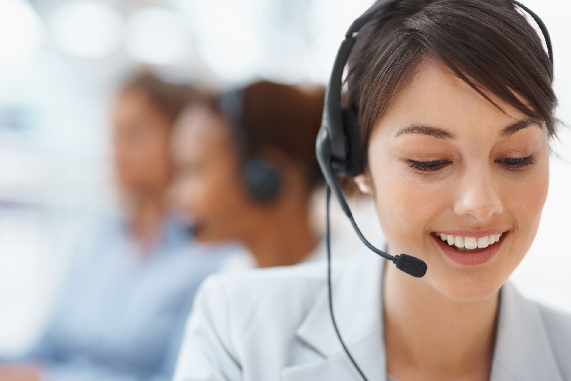 Smiling call center employee during a telephone conversation